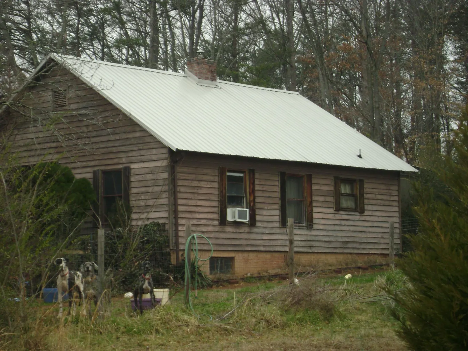 White metal roof on an old wood sided farmhouse, from a Metal Roof Installation job in Snyder